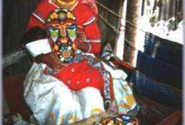 Huichol girl making a mask