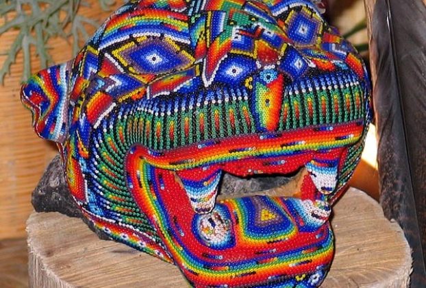 A Huichol jaguar head covered with intricate beadwork. The beads are applied one at a time with a needle, and are held in place with beeswax. © Kinich Ramirez, 2006