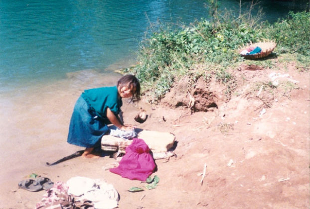 A girl washes clothes in a river in rural Chiapas. © Henry Biernacki, 2012