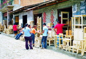 How much? Shoppers pause in their stroll along Cuanajo streets.