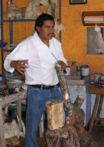 Jacobo Angeles of Oaxaca explains how tree bark yields a red pigment used to color his sculptures. © Alvin Starkman 2008