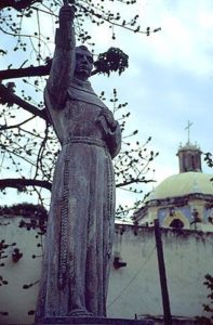 A statue honoring Fray Junipero Serra stands beside the Mission of Jalpan.