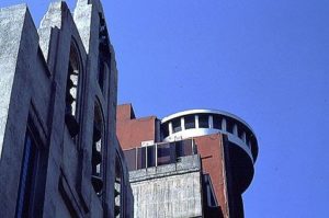 A cast-concrete cathedral shares the skyline with a surviving revolving roof-top restaurant, once considered to be the zenith of sophistication and progress in the sixties. Photography by Bill Begalke © 2001