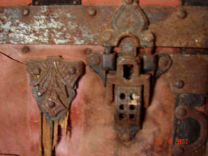 A lock protected its contents and ornate hardware was decorative while reinforcing the trunk