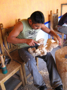 A cousin of Jacobo Angeles helps carve in the Mexican family's workshop. © Alvin Starkman 2008