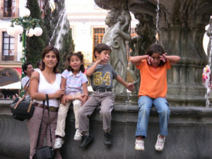 The author's niece - Teresina - with her children at the fountain in Puebla's main park for the Cinco de Mayo festivities. © Donald W. Miles, 2009