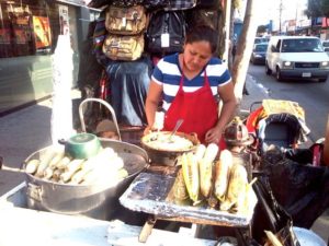 As it has been for thousands of years, corn is still a staple food in Mexico. This street stand offers tender boiled corn on the cob, corn roasted over a charcoal fire, and fresh cooked kernels mixed with cheese and thick cream. © Henry Biernacki, 2012