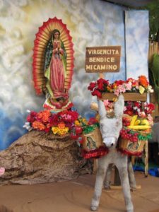 An outdoor photo set where children can have their photo taken. The sign says 'Virgen bless my path.' © Tara Lowry, 2014