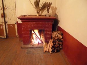 An open fire in the rooms of the former Mine Superintendent's Office makes for a cozy environment to keep out the cold and the wandering ghosts of Mexico's Dos Estrellas mine. The 19th century mine is located within the municipality of Tlalpujahua de Rayon in southern Michoacan, a few kilometers from the town of Tlalpujahua. © Anthony Wright, 2009