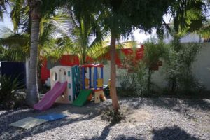 The Liga MAC courtyard offers plenty of space for meetings, yard sales, and a playground where children can relax while their parents work with counselors and administrators © Mariah Baumgartle, 2012