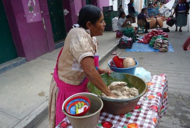 Gloria kneads the ground ingredients for tejate a final time at the market before ading the water to create a beverage. © Alvin Starkman, 2012