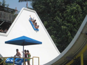 Three friends slide up and down, back and forth on El Péndulo in El Rollo Water Park in Morelos, Mexico. © Julia Taylor, 2008