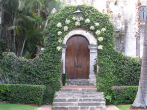 The entrance to the chapel is regally decorated with clusters of white flowers. Showing elegant, colonial Mexico. © Julia Taylor 2008