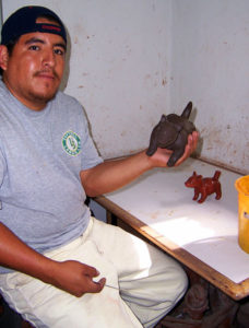 A worker shapes a Colima dog