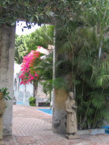 Carved from stone, images of saints stand watch beside a doorway in this beautiful Mexican hacienda. © Julia Taylor 2008