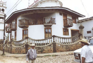 Wooden balconies overlook a downtown street in this typical Mazamitla home. The mountain town in Jalisco is a cool oasis in summer. © Tony Burton, 2000