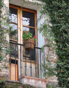 Tall doors in meter-thick walls at this Mexican colonial hacienda, open onto a wrought iron balcony. © Julia Taylor 2008