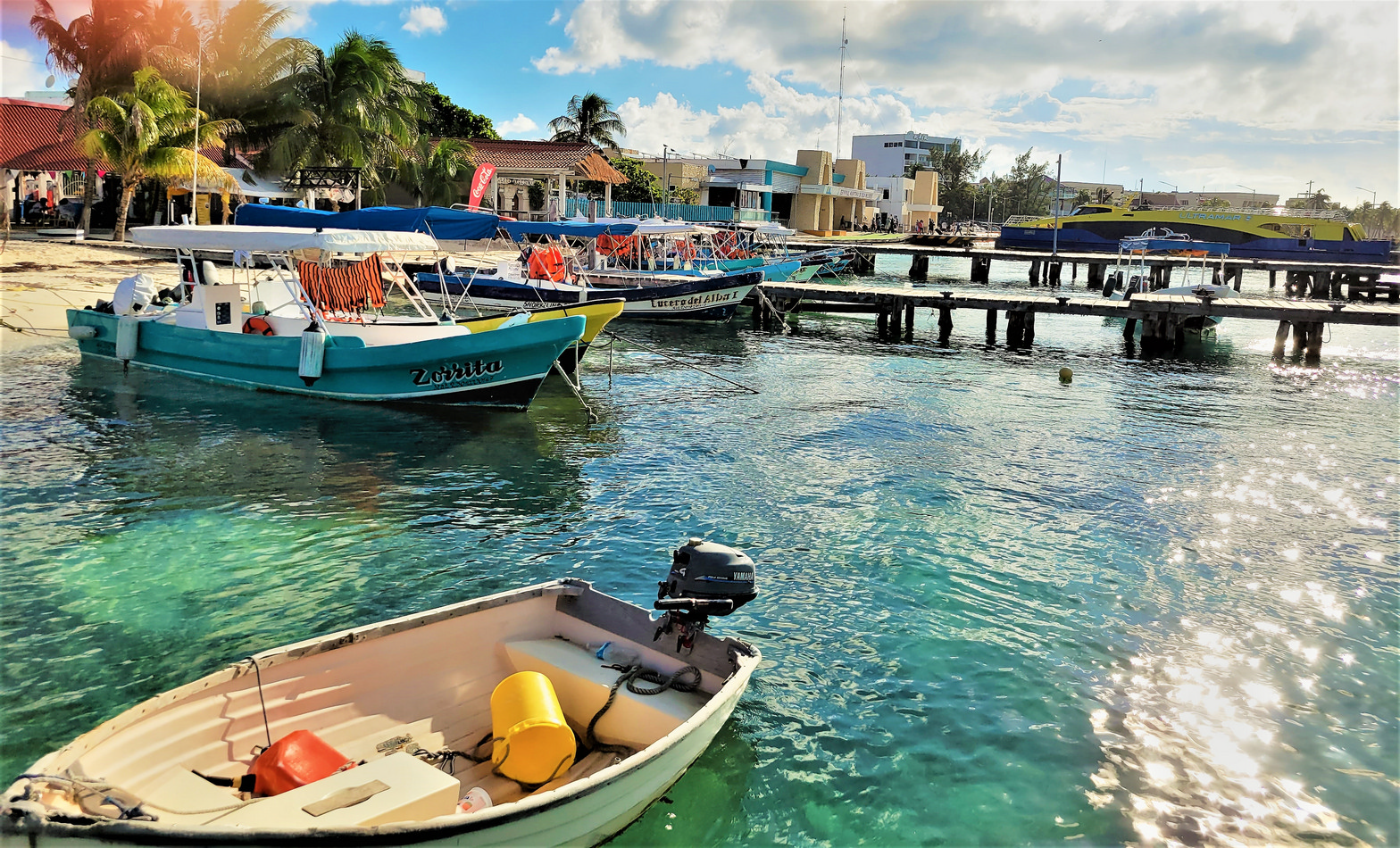 The boats from the mainland cross the Bahia de Mujeres to the downtown area where there are restaurants, shops, galleries, and golf cart rentals to navigate the island. © 2021 Jane Simon Ammeson