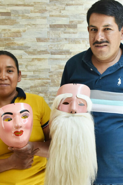 Graciela holds a mask made for a woman, and Javier has an Indio Serrano mask © Joseph Sorrentino, 2024