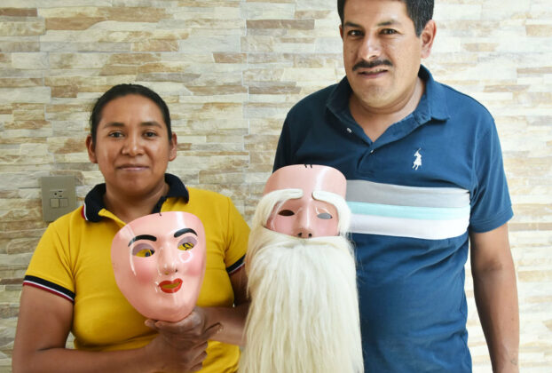 Graciela holds a mask made for a woman, and Javier has an Indio Serrano mask © Joseph Sorrentino, 2024