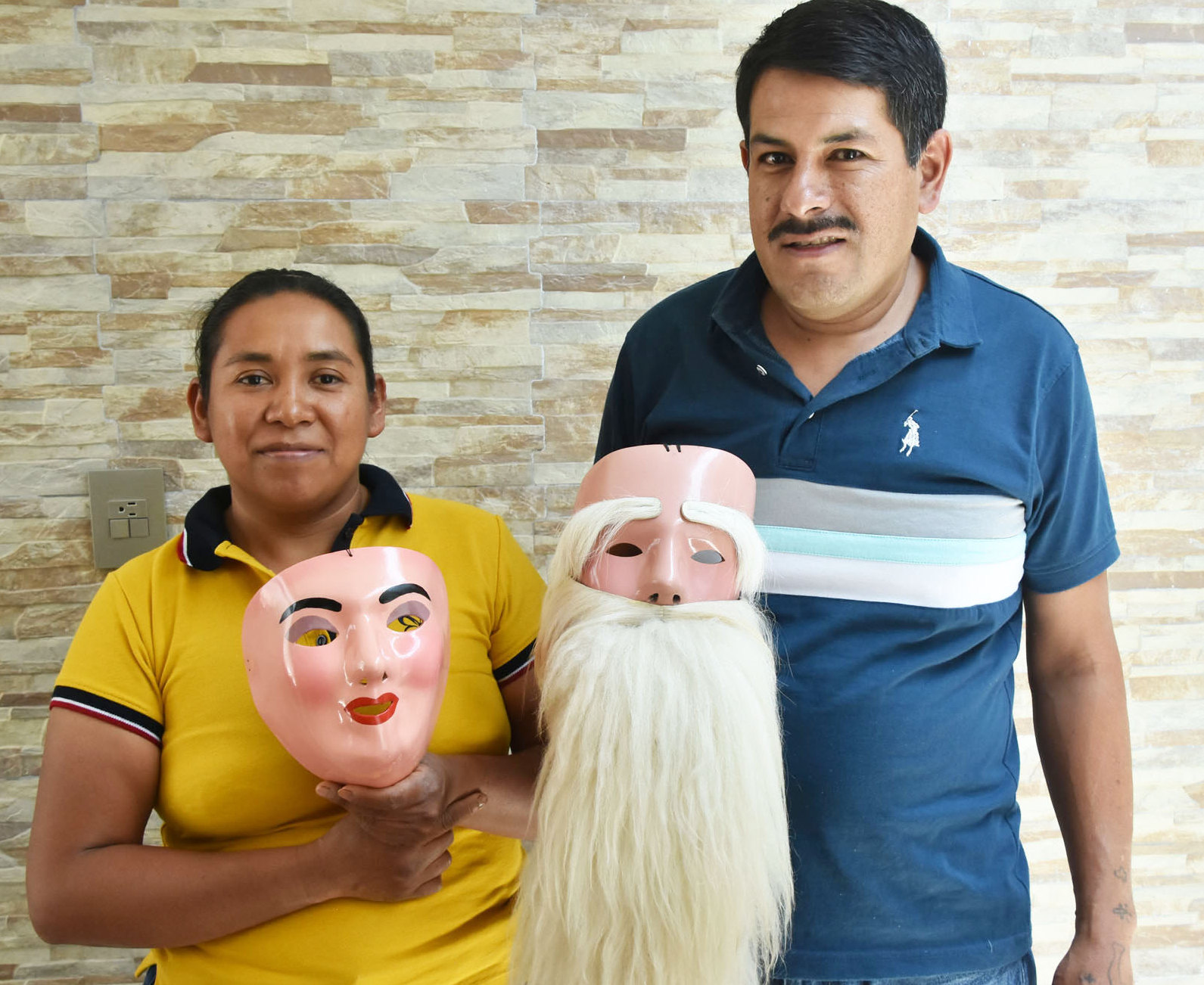 Graciela holds a mask made for a woman, and Javier has an Indio Serrano mask © Joseph Sorrentino, 2024